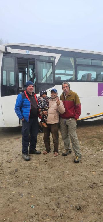 Happy guests with local family near the hotel